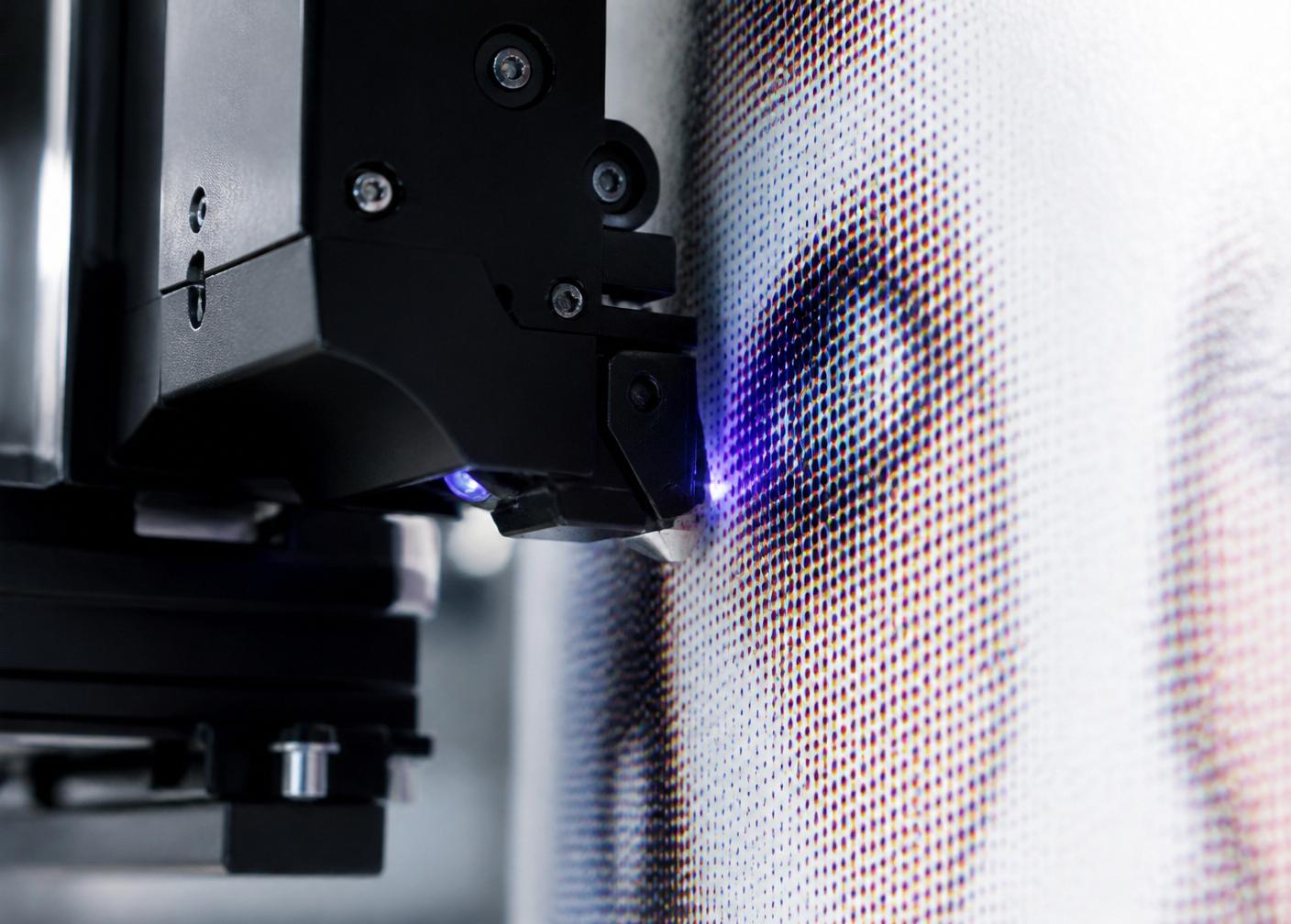 Close-up of the UV printhead depositing pigment on a wall